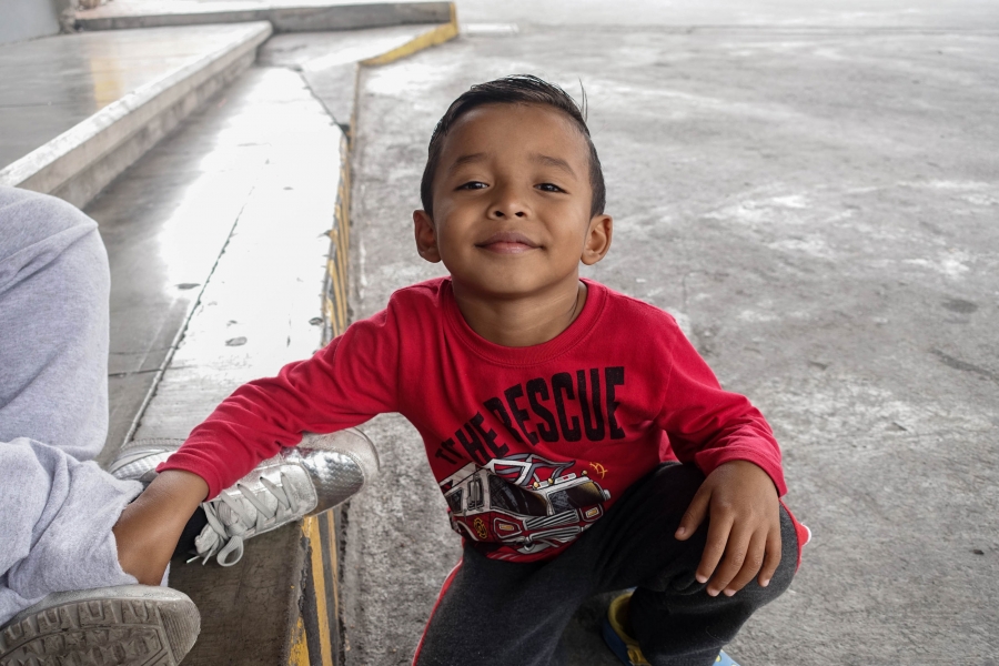 A portrait of a young boy in a red shirt. A portrait of a young boy in a red shirt.