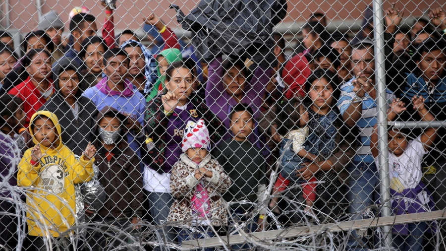 Central American migrants are seen inside an enclosure where they are being held by US Customs and Border Protection. Central American migrants are seen inside an enclosure, behind a chain-link fence, where they are being held by US Customs and Border Protection.