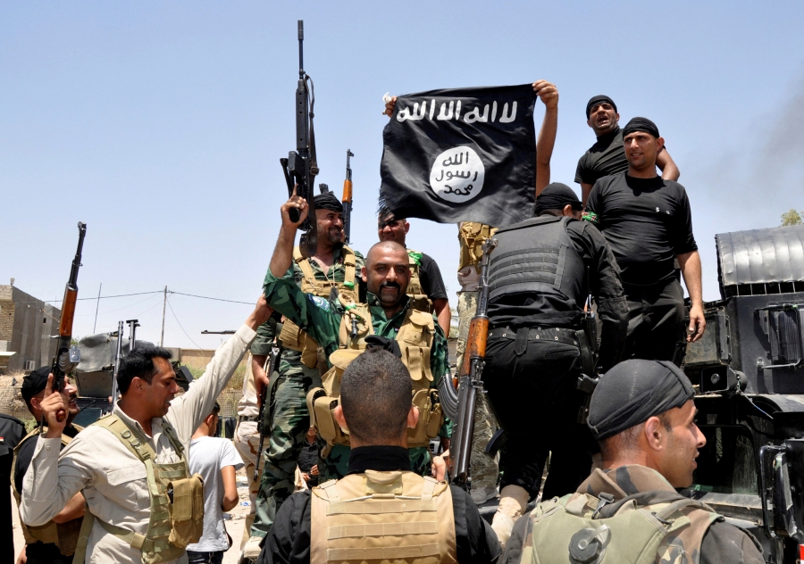 men on military truck capture ISIS flag