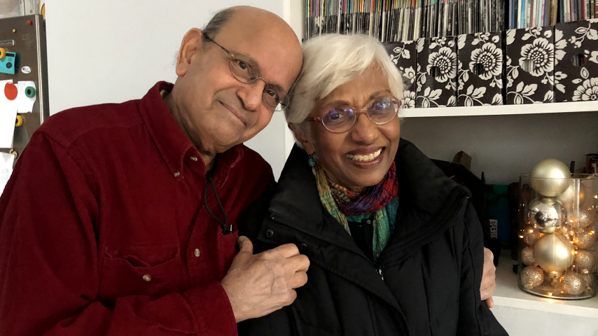 An older man and woman pose together