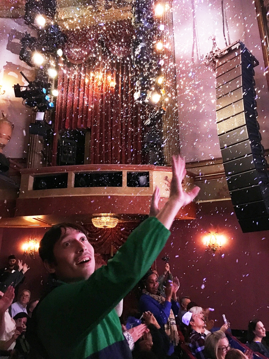An audience member reaches for the confetti at the close of the show. An audience member reaches for the confetti at the close of the show.