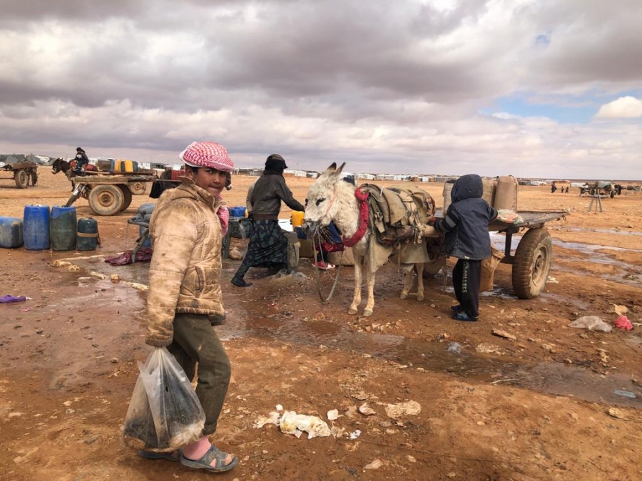 Rukban's only infrastructure is water piped in from Jordan — but it's unfiltered. When it runs out, the price can spike to up to eight times to normal value. A boy stands near a donkey waiting to fetch water.