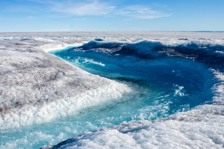 Some of the surface of the Greenland ice sheet melts every summer, forming streams, rivers and lakes that often empty into holes and fissures. A winding flow of water is shown on the Greenland ice sheet