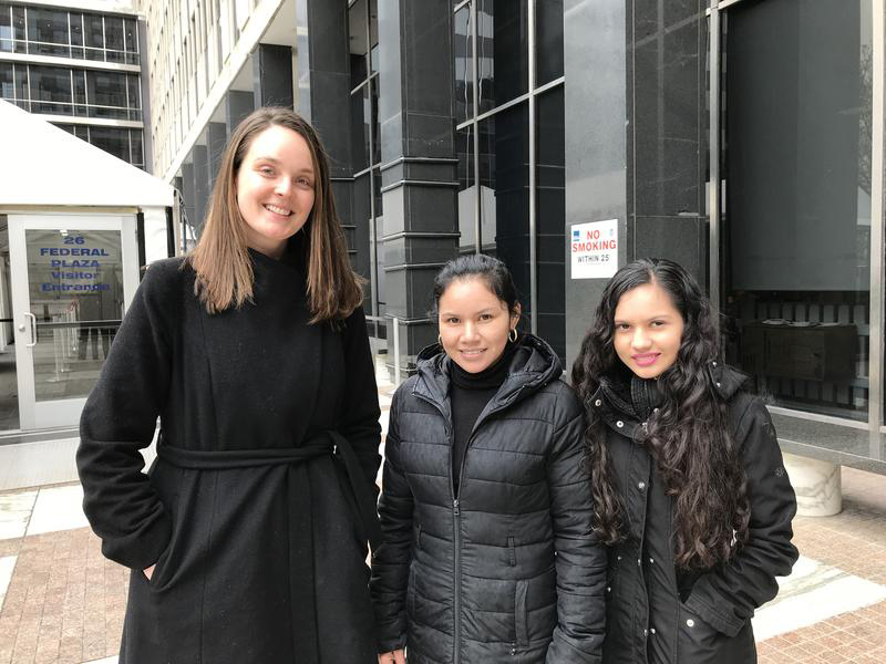 Three women smile for the camera