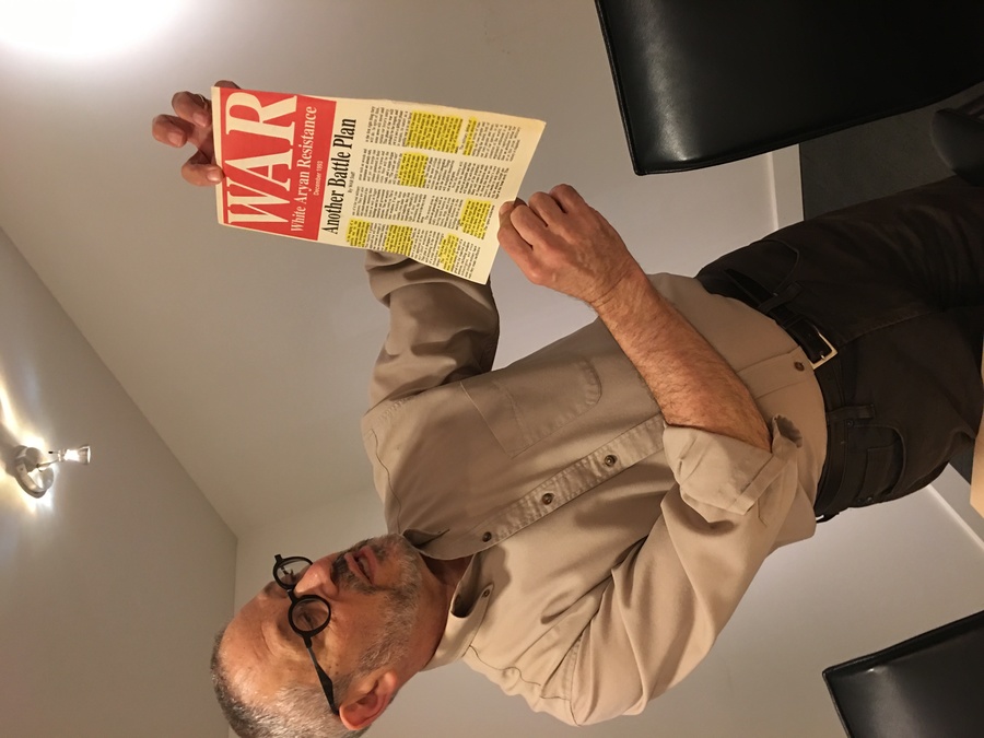Steven Wasserstrom, a professor of Judaic studies and the humanities at Reed College, holds a piece of documentation collected by the Coalition for Human Dignity in Portland.