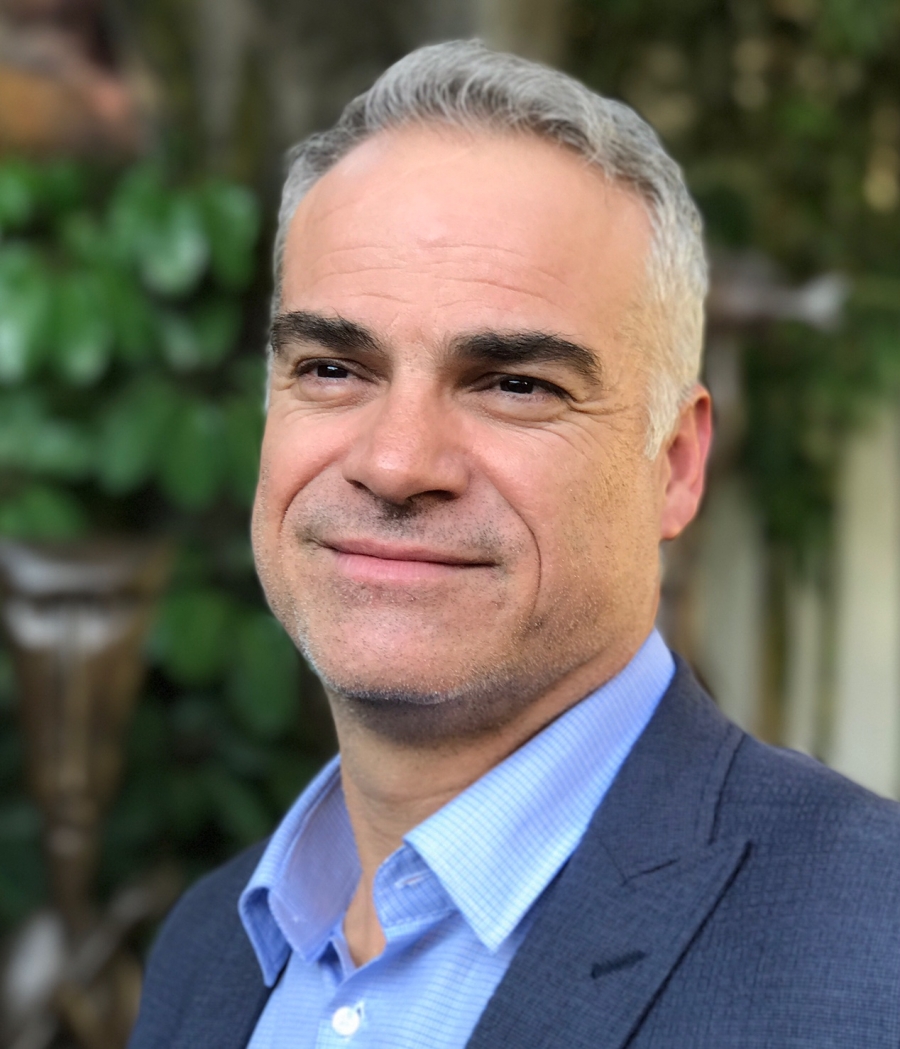 A man is smiling in a photograph.