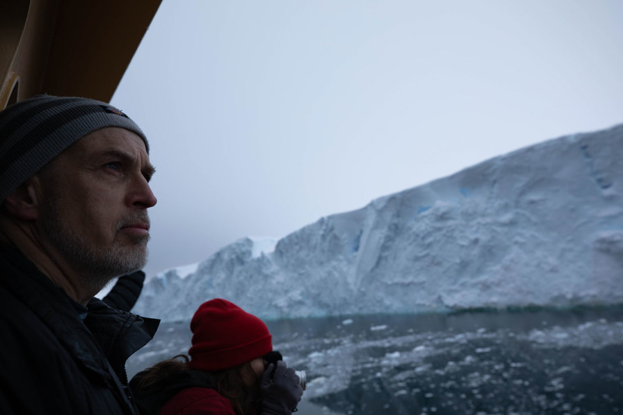 Chief Scientist Rob Larter looks out at the glacier on the morning of arrival. Chief Scientist Rob Larter is shown in the nearground looking out at Thwaites glacier on the morning of arrival.
