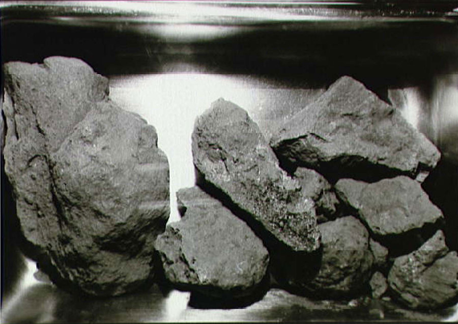 A close-up view of the lunar rocks contained in the second Apollo 11 sample return container. Several rocks from the surface of the moon are shown next to each other.