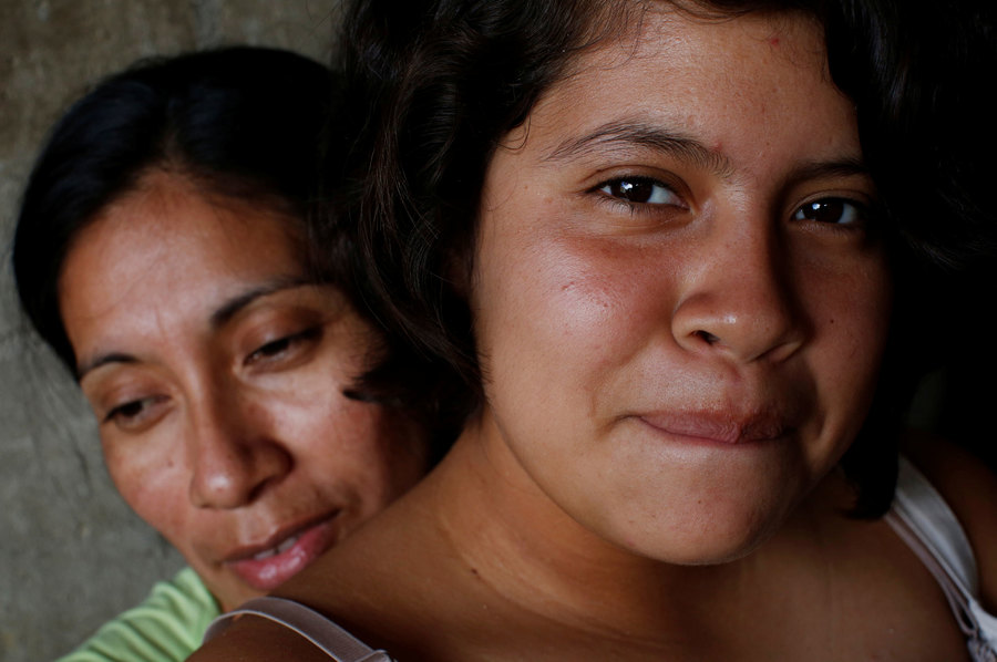 Consuelo Aguilar, 36, and her daughter Andrea, 15, sit inside a shelter after they were sent by the Customs and Border Protection to Mexico from the US under the MPP. An older woman and her teenage daugter show shown in a close-up photograph with the daughter looking directly at the camera.