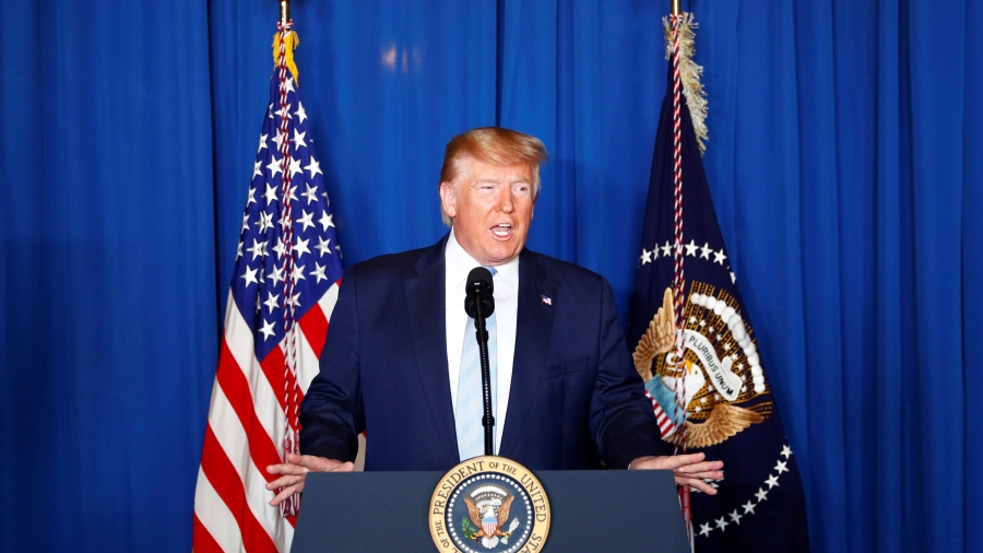 US President Donald Trump delivers remarks following the US Military airstrike against Iranian Maj. Gen. Qasem Soleimani Trump stands behind a podium
