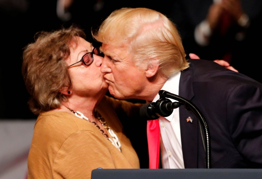 US President Donald Trump receives a kiss from Cuban dissident Cary Roque at an event where he announced his Cuba policy at the Manuel Artime Theater in the Little Havana neighborhood in Miami, Florida, June 16, 2017. US President Donald Trump receives a kiss from Cuban dissident Cary Roque at an event where he announced his Cuba policy at the Manuel Artime Theater in the Little Havana neighborhood in Miami, Florida, June 16, 2017.