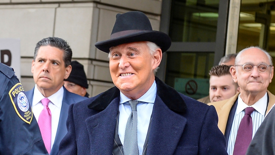 Roger Stone A man smiling in a hat surrounded by people