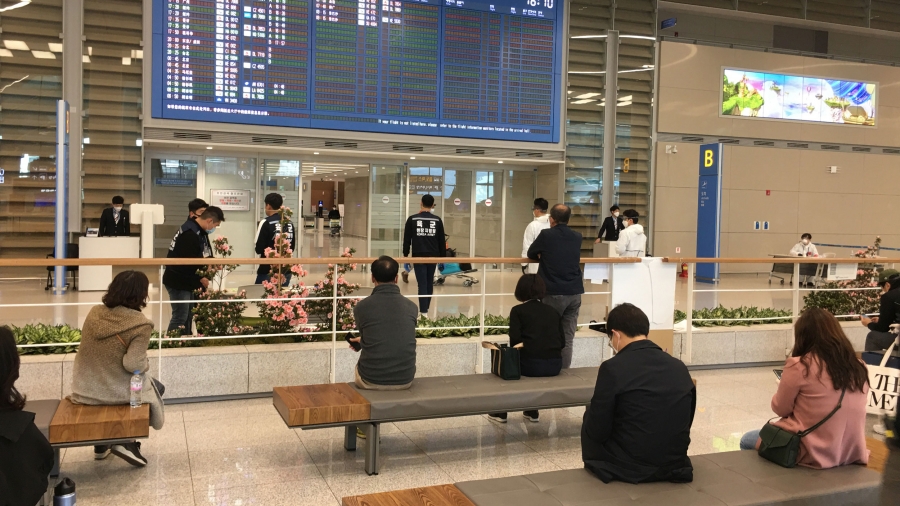 People sit in an airport terminal