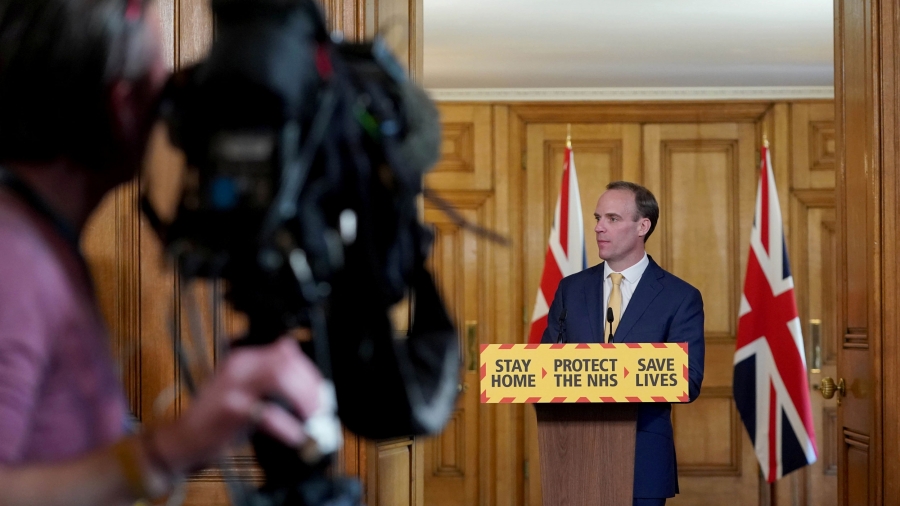 Britain's Foreign Secretary Dominic Raab speaks as he holds a COVID-19 press conference at 10 Downing Street in London, Britain, April 7, 2020. Britain's Foreign Secretary Dominic Raab is shown standing behind a podium witth the words, "Stay Home, Protect the NHS, Save Lives" printed on it.