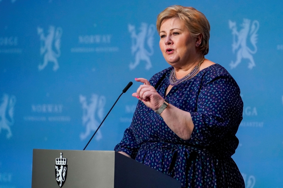Norway's Prime Minister Erna Solberg A woman stands at a podium speaking