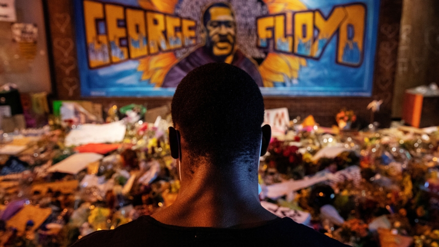 A man recites spoken word poetry at a makeshift memorial honoring George Floyd at the spot where he was taken into custody, in Minneapolis, June 1, 2020. A man recites spoken word poetry at a makeshift memorial honoring George Floyd at the spot where he was taken into custody, in Minneapolis, June 1, 2020.