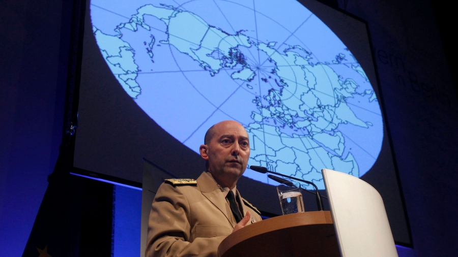 NATO Supreme Allied Commander Europe US Navy Admiral James Stavridis delivers a speech before a panel discussion in Berlin, Jan. 24, 2012. A man stands at a podium with an image of a globe behind him