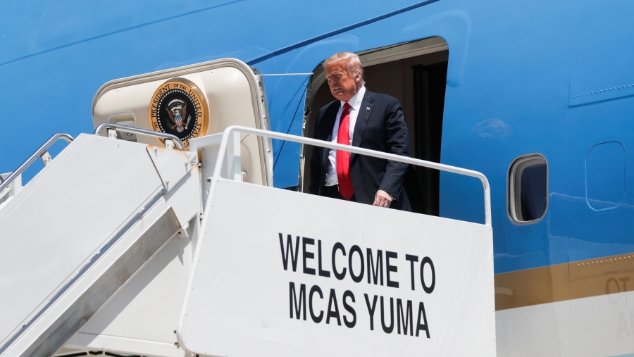 US President Donald Trump arrives aboard Air Force One to visit a nearby US-Mexico border wall site in Yuma, Arizona, June 23, 2020. US President Donald Trump is shown exiting the blue-painted Air Force One on a white platform with the words, "Welcome to MCAS Yuma" painted on the side.