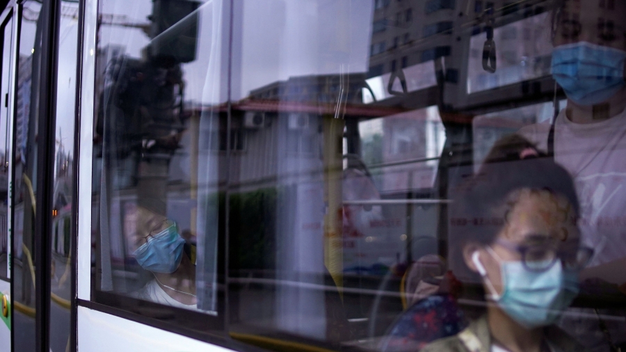 Women wearing protective face masks are seen in a bus, following the coronavirus disease (COVID-19) outbreak, in Shanghai,ย June 9, 2020.ย Women wearing protective face masks are seen in a bus, following the coronavirus disease (COVID-19) outbreak, in Shanghai,ย June 9, 2020.ย