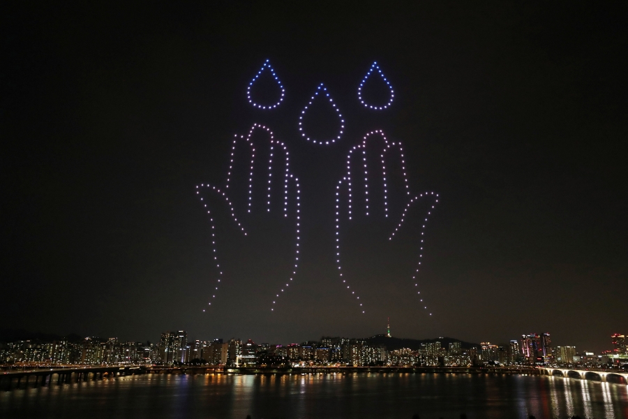 The drone display took place as measures to avoid the spread of COVID-19 continue in Seoul. South Korea new virus daily cases stayed just above 60 over the weekend. Two hand and three drops of water are drawn in the sky with the lights of small drones in Seoul.