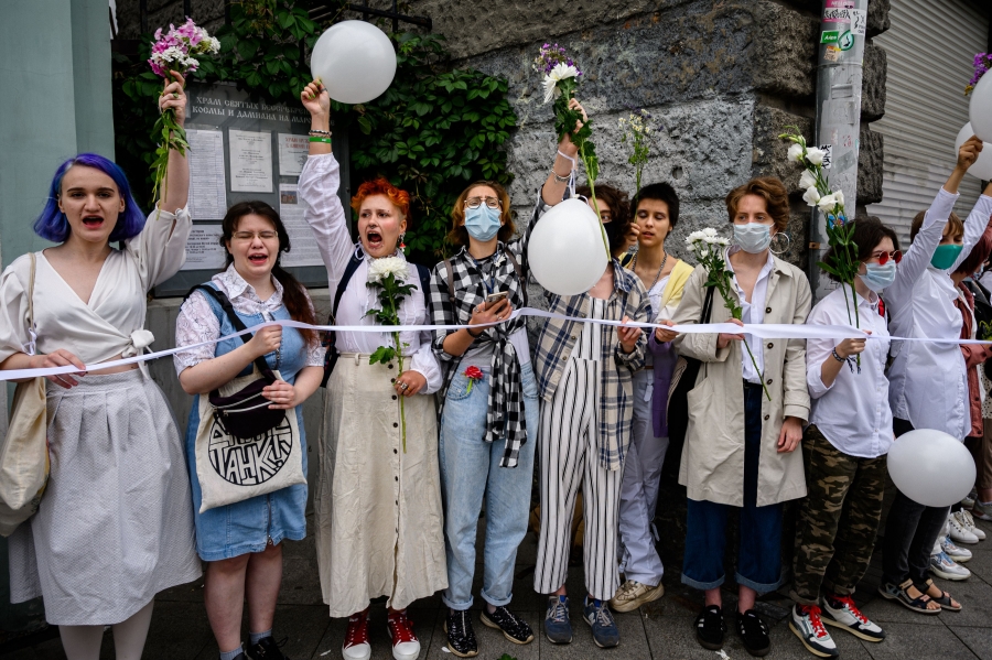 The women in white demand a redo of Belarus’s Aug. 9 election, which they say Lukashenko stole, Aug. 15, 2020. A line of standing women protesters.