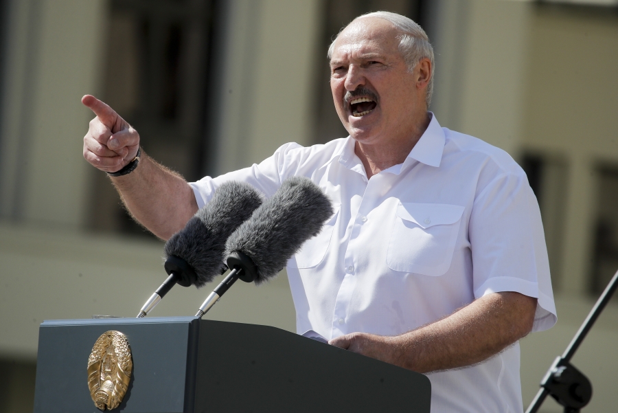 Lukashenko addresses several thousand supporters in Minsk, Aug. 16, 2020. Alexander Lukashenko passionately speaks into a microphone, with his hand up and finger waving at the audience.