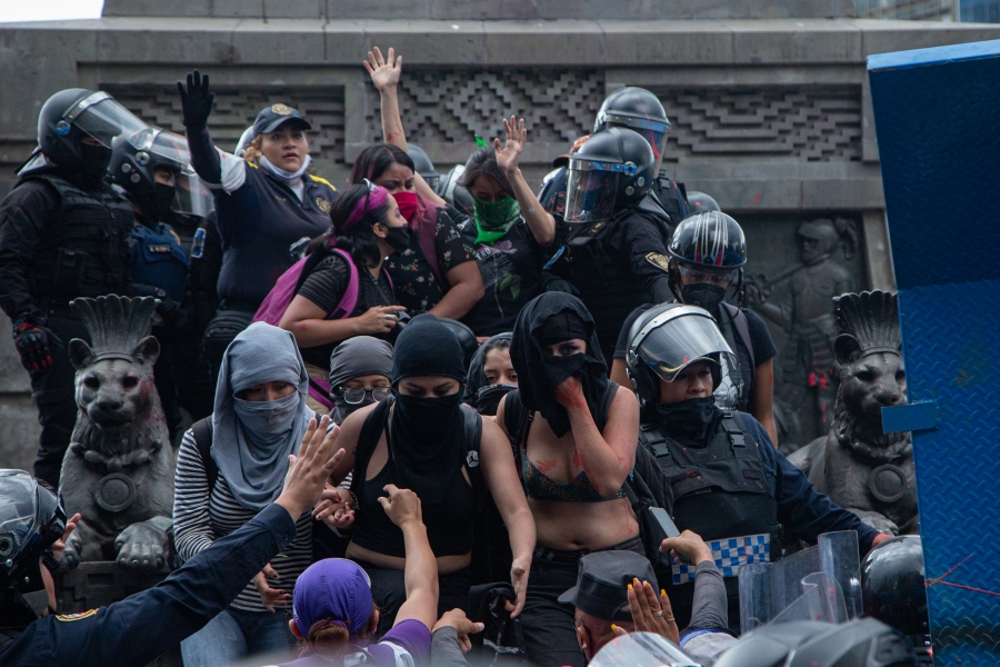 Women demand justice for Mexico’s many murdered women at a protest against gender violence in Mexico CIty, Aug. 15, 2020. Women protesters face off with Mexican officials.
