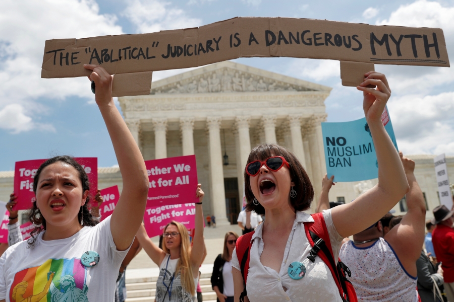 Public faith in the U.S. Supreme Court, a once-venerated institution, has been declining for years. Two woman protestors outside the Supreme Court.