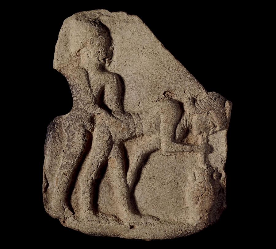 Clay plaque showing a man and woman having sex, while the woman drinks beer through a straw (Old Babylonian period, c. 1800 B.C.). A stone carving of two people.