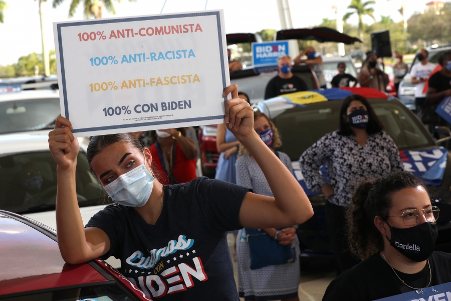 An anti-communism, pro-Biden voter in Miramar, Fla., Oct. 13, 2020. A woman holds up a sign in support of Biden and against Trump.