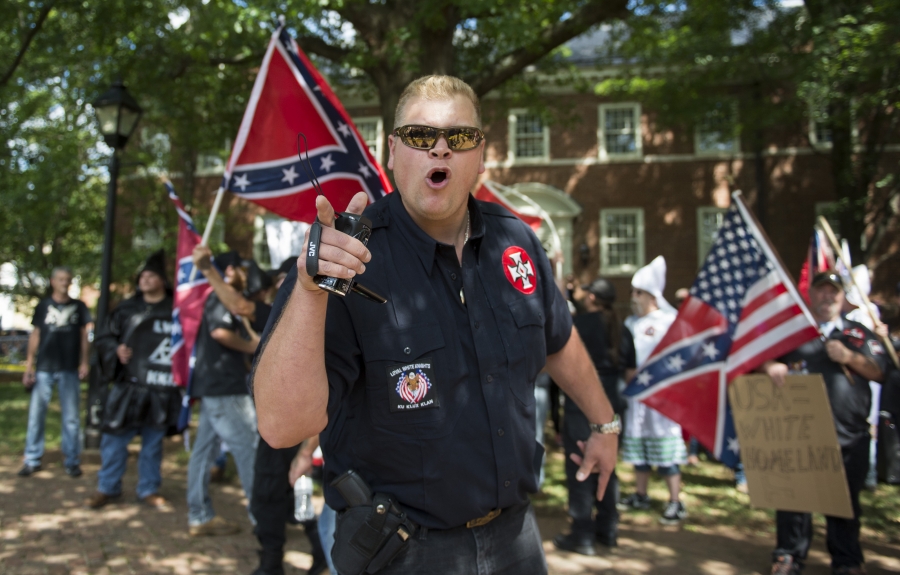Parler has become a haven for overt white supremacists and anti-Semites. A white supremacist cheers with a crowd.
