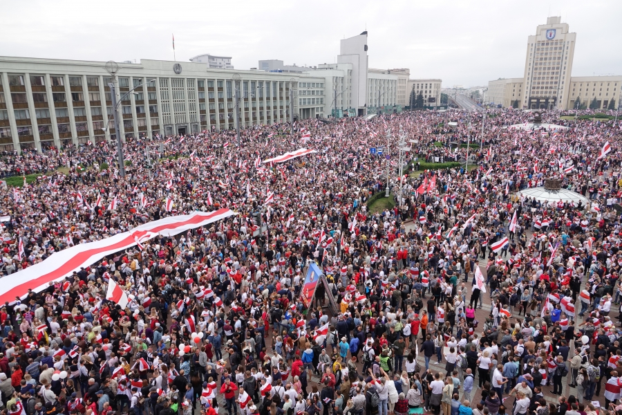 Thousands of people gather in Minsk to call for the resignation of President Alexander Lukashenko, on Aug. 23, 2020. A massive crowd of people gather for a protest in the Belarusian capital. The nation's flag colors, red and white, are apparent throughout the photo.