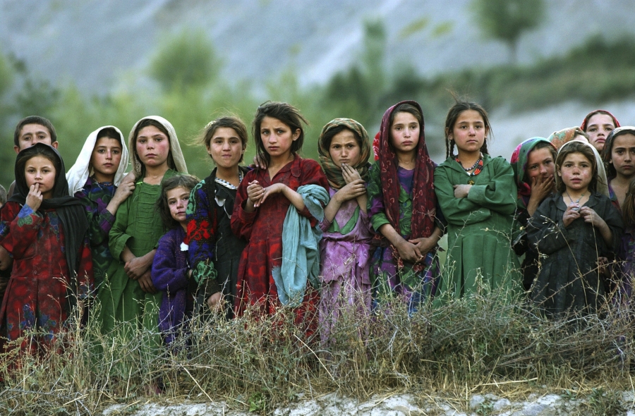 Local girls look at UN workers unloading ballot kits from a UN helicopter in Ghumaipayan Mahnow village, some 256 miles)northeast of Kabul, Afghanistan, on Oct. 4, 2004. By air was the only way to deliver the electoral material in the inaccessible areas o Local girls look at UN workers unloading ballot kits from a UN helicopter in Ghumaipayan Mahnow village, some 256 miles)northeast of Kabul, Afghanistan, on Oct. 4, 2004. By air was the only way to deliver the electoral material in the inaccessible areas o