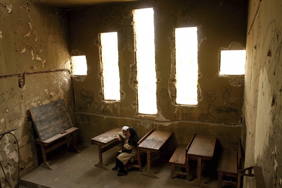 Basera, 13, right, and Saira, 10, wait for their class to begin at Loy Ghar school, in the bombed-out carcass of the Kabul Theater in Afghanistan's capital, April 20, 2005. The bullet-riddled building became a place of hope for more than 400 students look Basera, 13, right, and Saira, 10, wait for their class to begin at Loy Ghar school, in the bombed-out carcass of the Kabul Theater in Afghanistan's capital, April 20, 2005. The bullet-riddled building became a place of hope for more than 400 students look