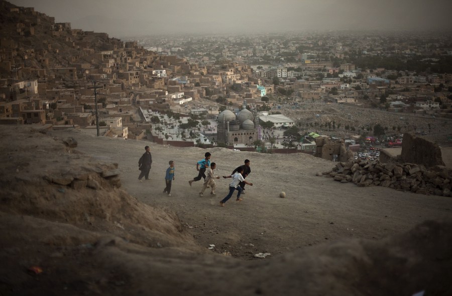 Afghan children play football in a street in Kabul, Afghanistan, on July 17, 2009. Afghan children play football in a street in Kabul, Afghanistan, on July 17, 2009.