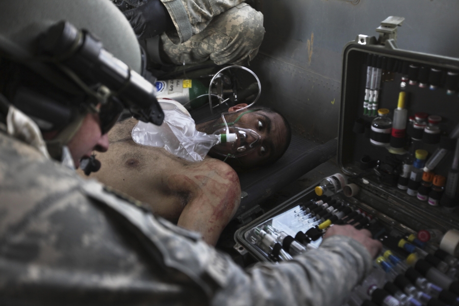 Airborne in a US Army Task Force Pegasus helicopter, US Army Staff Sgt. and flight medic Robert B. Cowdrey, of La Junta, Colo., gives medical care to an Afghan National Army soldier with a gunshot wound, during a medevac mission over Marjah, Helmand provi Airborne in a US Army Task Force Pegasus helicopter, US Army Staff Sgt. and flight medic Robert B. Cowdrey, of La Junta, Colo., gives medical care to an Afghan National Army soldier with a gunshot wound, during a medevac mission over Marjah, Helmand provi