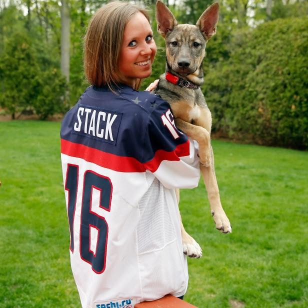 Kelly Stack, ice hockey player for Team USA and 2014 Sochi Olympian with Shayba, a German shepherd mix whose name in Russian means "hockey puck."