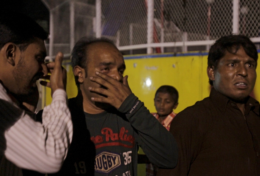 Men mourn the death of their relatives