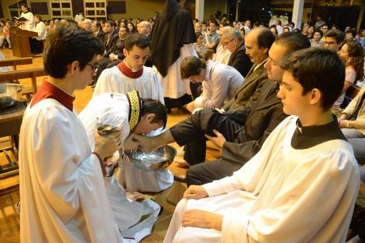 Father Carlos Urrutigoity kisses the foot of a congregant in Ciudad Del Este. Father Carlos Urrutigoity kisses the foot of a congregant in Ciudad Del Este.