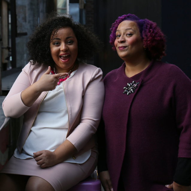 Two women, smiling