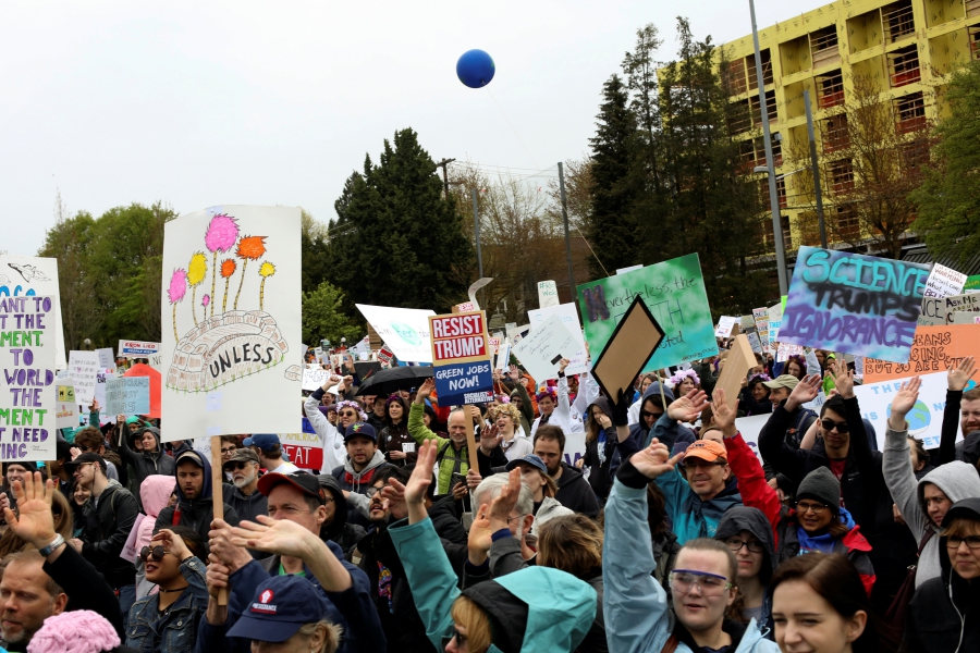 Protestors hold signs during the March For Science in Seattle, Washington, April 22, 2017.