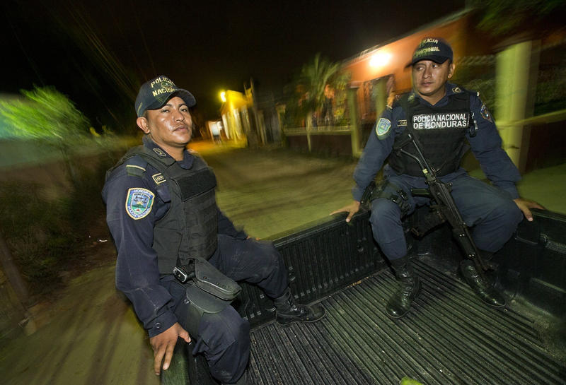 Honduran police officers Edilberto Hernández and Marvin Castro patrol the Chamelecón neighborhood in San Pedro Sula, Honduras. Honduran police officers Edilberto Hernández and Marvin Castro patrol the Chamelecón neighborhood in San Pedro Sula, Honduras.