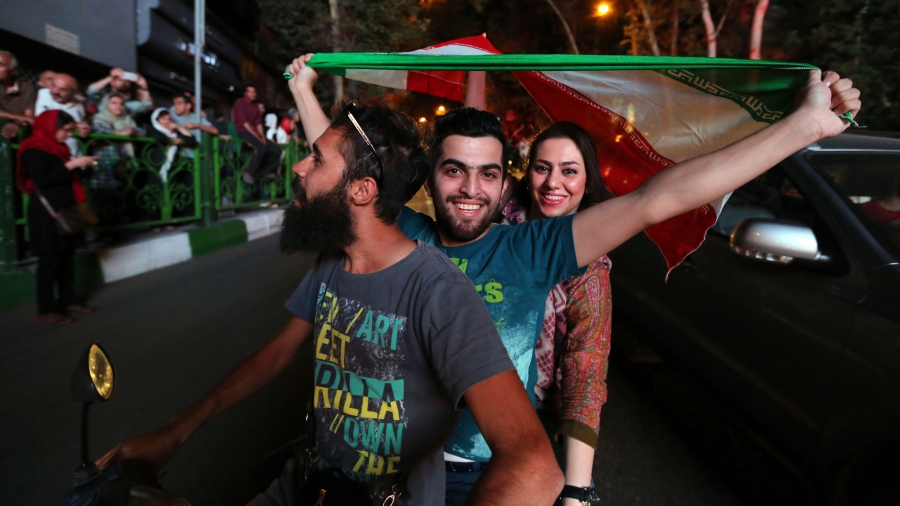 Iranians wave the national flag during celebrations in Tehran on July 14, 2015, after Iran's nuclear negotiating team struck a deal with world powers in Vienna. Iranians wave the national flag during celebrations in Tehran on July 14, 2015, after Iran's nuclear negotiating team struck a deal with world powers in Vienna.
