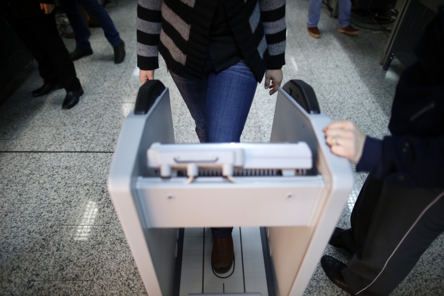A woman goes through security checks at the Sarajevo International Airport in Sarajevo February 26, 2014. A woman goes through security checks at the Sarajevo International Airport in Sarajevo February 26, 2014.