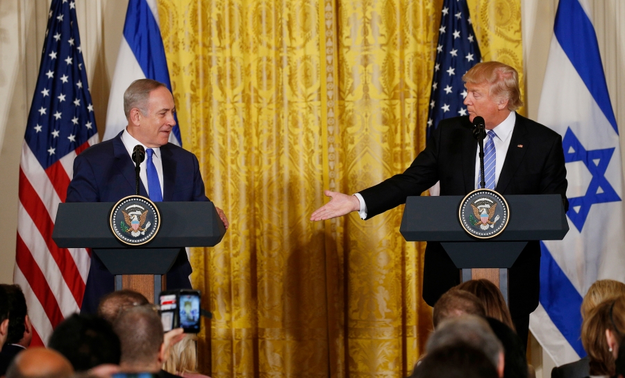 US President Donald Trump (right) reaches to greet Israeli Prime Minister Benjamin Netanyahu after a joint news conference at the White House in Washington, DC, on February 15, 2017. US President Donald Trump (right) reaches to greet Israeli Prime Minister Benjamin Netanyahu after a joint news conference at the White House in Washington, DC, on February 15, 2017.
