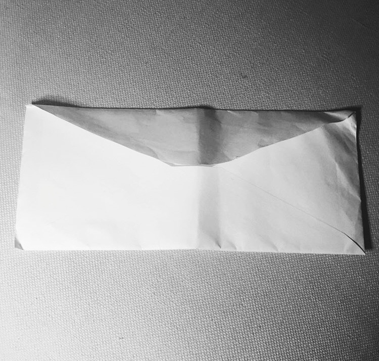 The Franceschini family asked us to bring this letter to Puerto Rico to give to their grandmother, Nereida. A close up of a white envelope containing a letter.