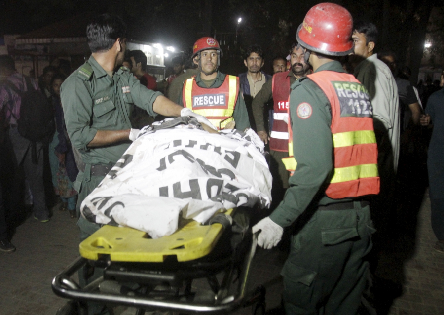 Rescue workers move a body