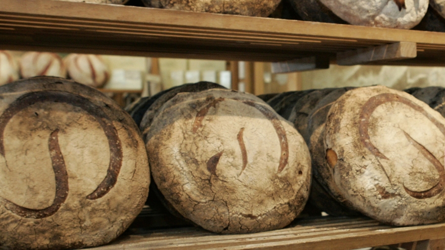 Freshly baked Miche line the walls at the original Poilane family bread bakery in Paris. Freshly baked Miche line the walls at the original Poilane family bread bakery in Paris.
