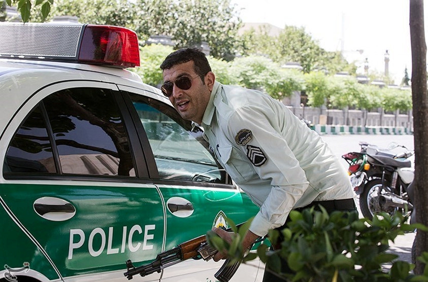 An Iranian policeman takes cover during an attack on the Iranian parliament in central Tehran, Iran, June 7, 2017.