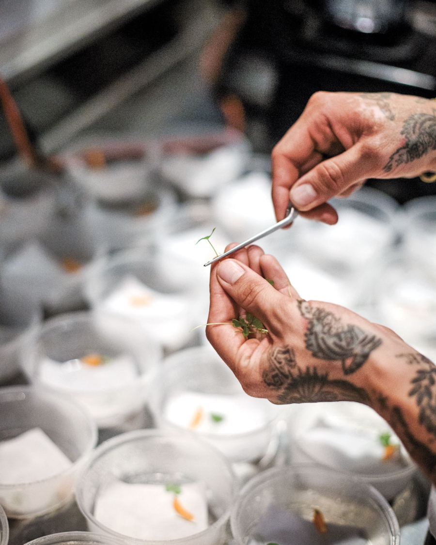 Placing a green leaf on a dish. Placing a green leaf on a dish.